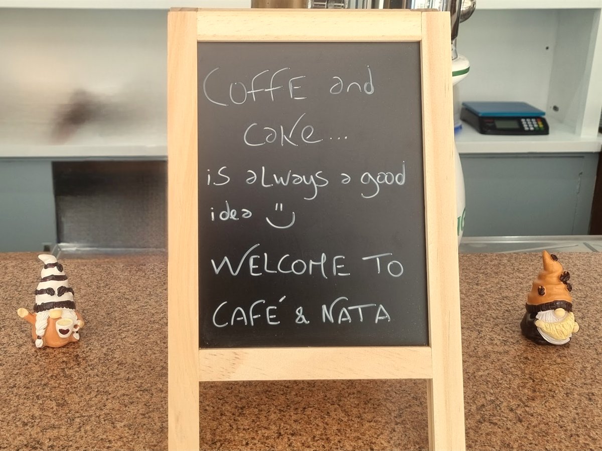 Handwritten chalkboard welcome sign at Café & Nata